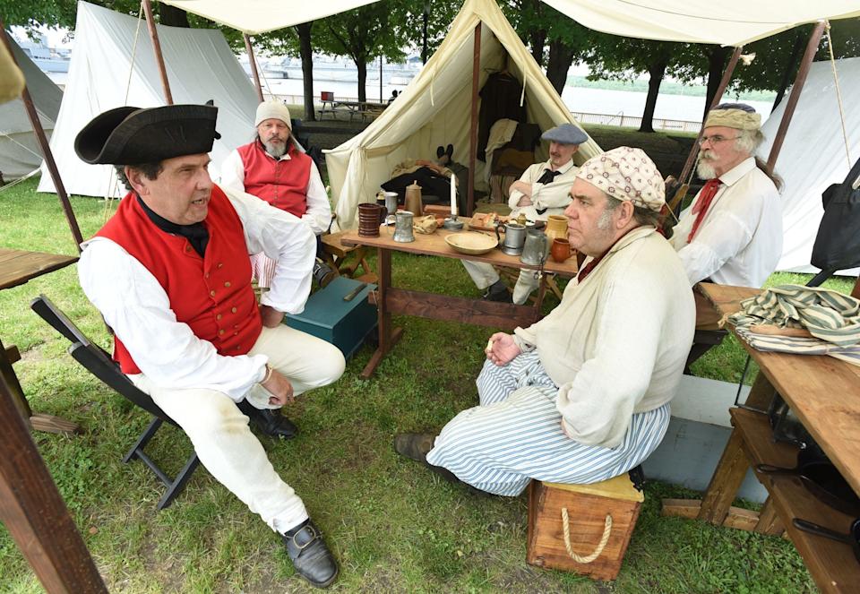Making battle plans, this band of Loyalists, from left, Joe Pereira, of Fall River, Steve Carter of Middletown, Conn., Scott Smith of Taunton, Steve Barratt of Hamden, Conn., and Doug Rankin of Taunton, are on hand for the 240th anniversary of the Battle of Fall River, Saturday, June 2, 2018, at Heritage State Park in Fall River, Massachusetts. [Herald News Photo | Jack Foley]