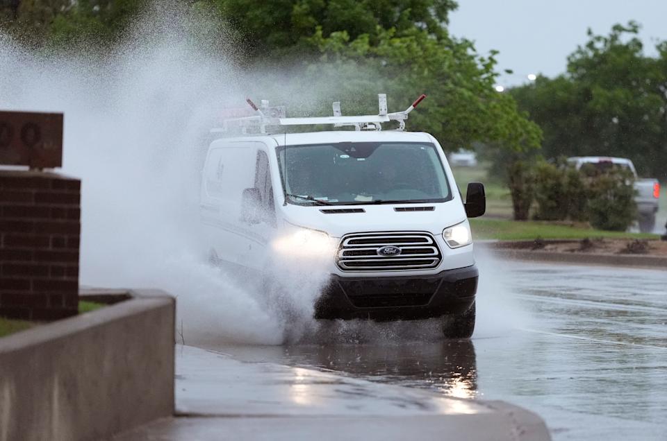 A van is drivesn through standing water April 30 on Kelly Ave in Edmond.