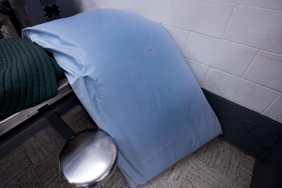 Detention Officer Serna shows the mattress issued to inmates on Tuesday, April 2, 2025, at the El Paso County Downtown Detention Facility.