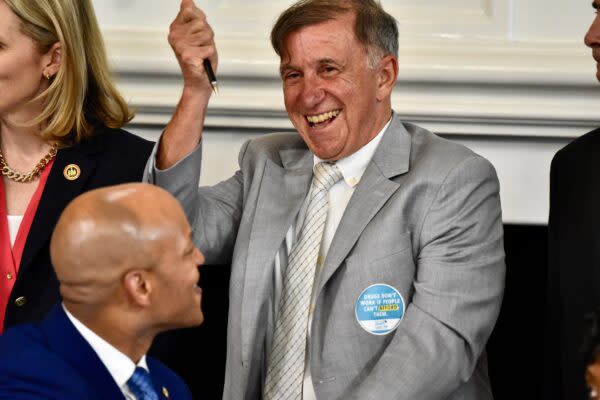 Vincent DeMarco, president of Maryland Health Care for All, celebrates the governor’s approval of legislation that could help Marylanders save on prescription drug costs. (Photo by Bryan P. Sears/Maryland Matters)