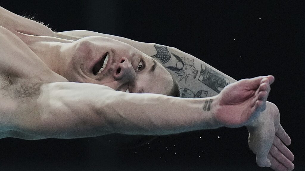 AP PHOTOS: Expressions of divers in the split second between diving board and the water
