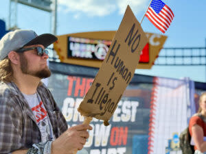 Protesters lined a corridor outside of the College World Series and its “Greatest Show on Dirt.” (Cindy Gonzalez/Nebraska Examiner)