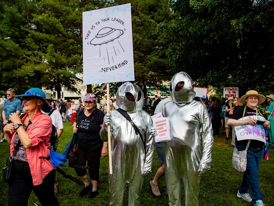 Protesters gather at Martin Luther King Jr. Park, June 14, 2025, for the "No Kings" protest in response to the Trump administration's plans to hold a large-scale military parade Saturday, an event that will include vintage warplanes, thousands of soldiers, horses and more.
