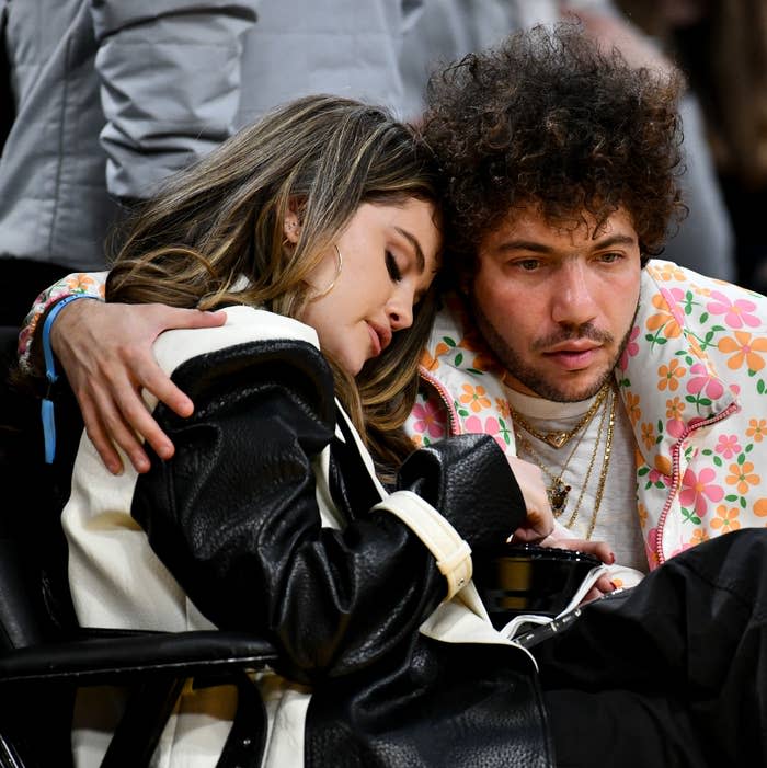 Selena Gomez and Benny Blanco embracing at a basketball game
