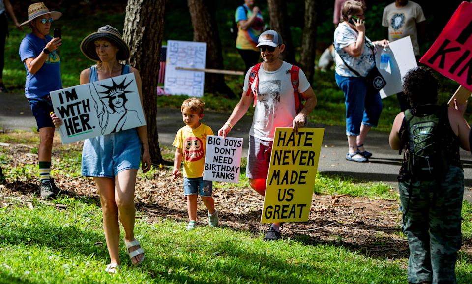 Protesters gather at Martin Luther King Jr. Park, June 14, 2025, for the "No Kings" protest in response to the Trump administration's plans to hold a large-scale military parade Saturday, an event that will include vintage warplanes, thousands of soldiers, horses and more.
