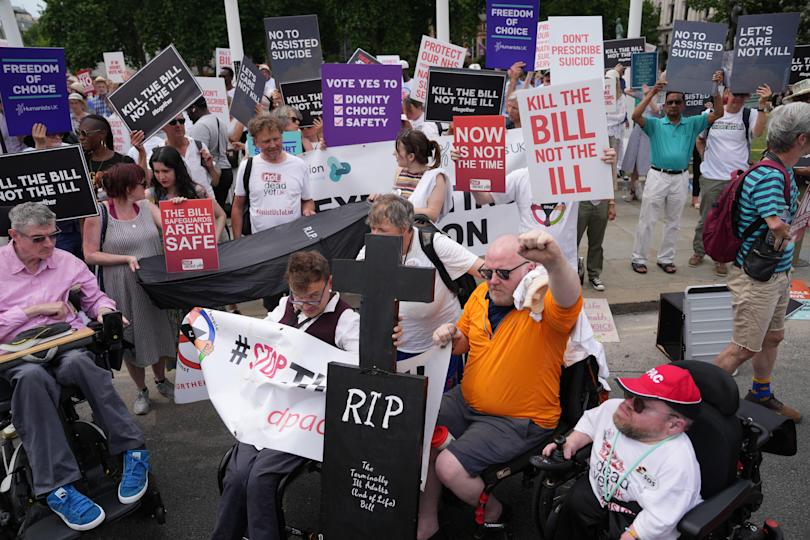 Protesters against a change in the law on assisted dying hold placards during a demonstration outside The Palace of Westminster, home to the Houses of Parliament in central London, June 20, 2025. / Credit: CARLOS JASSO/AFP/Getty