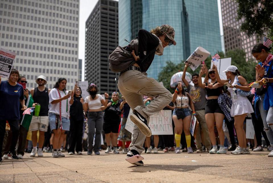 Protestors dance in a circle during a No Kings protest at City Hall, Saturday, June 14, 2025, in Houston. (Antranik Tavitian for The Texas Tribune)