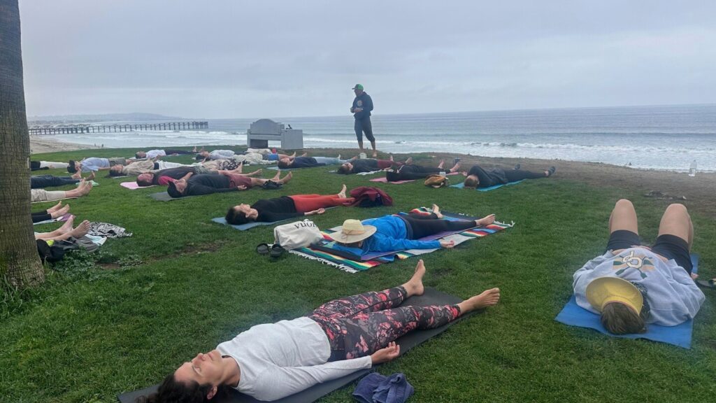 A yoga teacher sued after San Diego cracked down on beachfront classes. Now, he’s teaching again